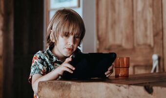 Young boy plays with ipad