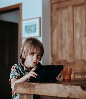 Young boy plays with ipad