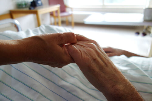 Holding the hand of patient