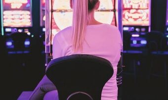 Female sat in front of gambling machines nu
