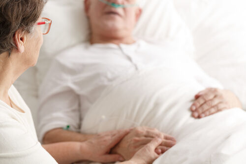 Married older couple hospital bed