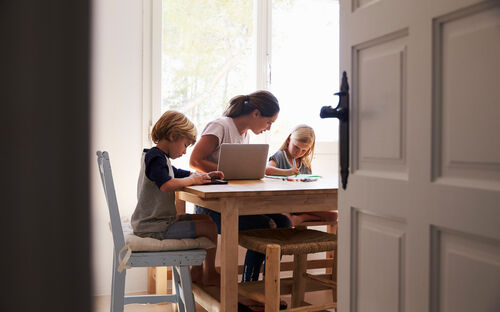 Woman with children home table