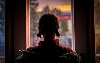 Woman looking out window silhouette exploitation small